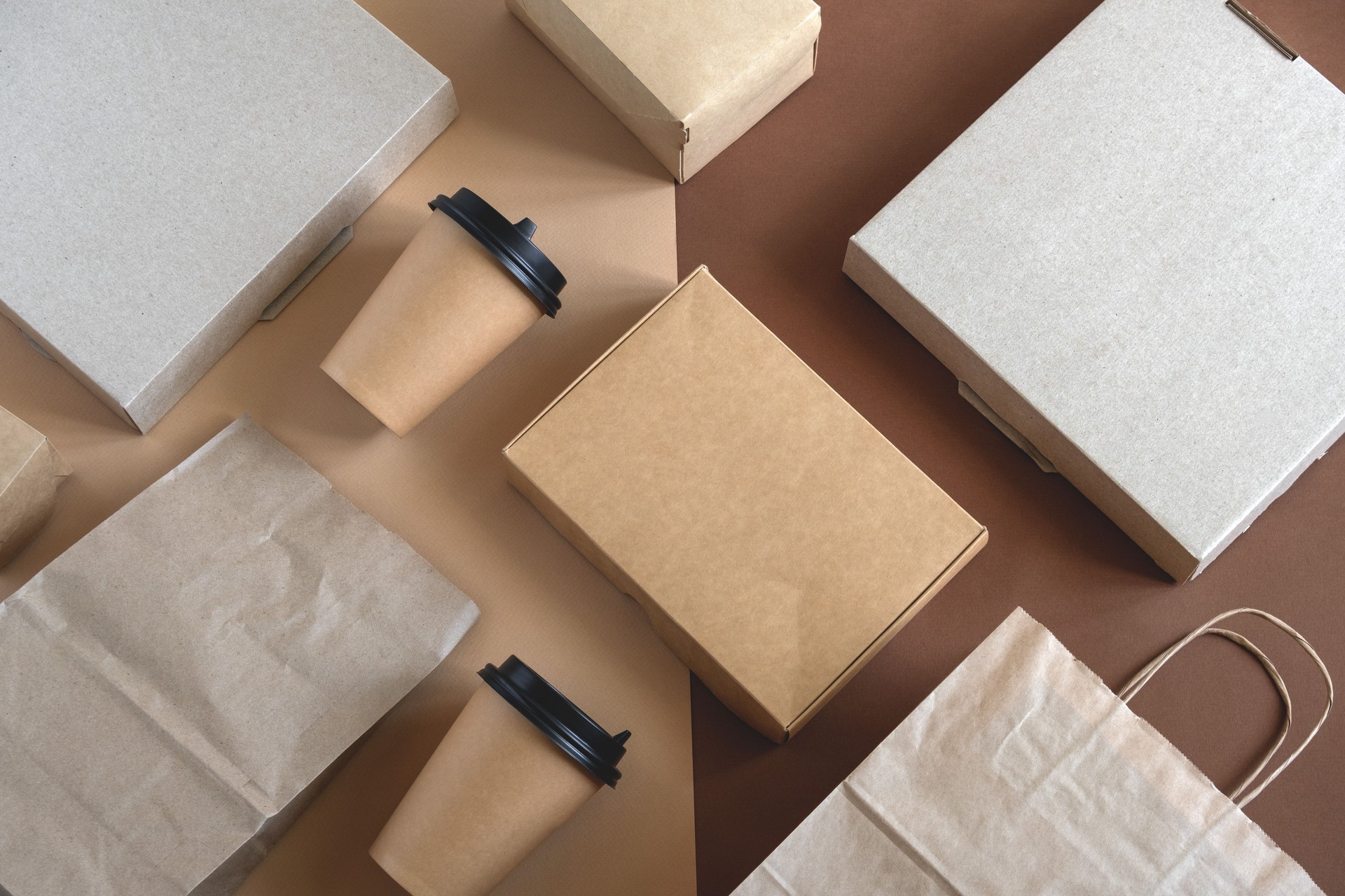 disposable blank delivery food packaging on a beige and brown background